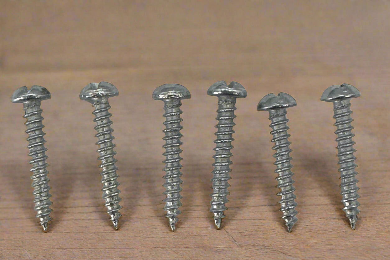 Six metal screws arranged vertically on a wood background